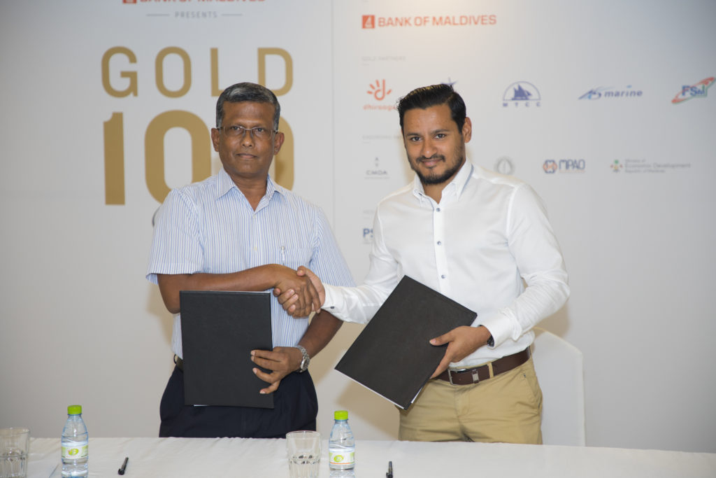 Maldives Getaways CEO Dr Hussain Sunny Umar signs with Gold Partner : M7 Print